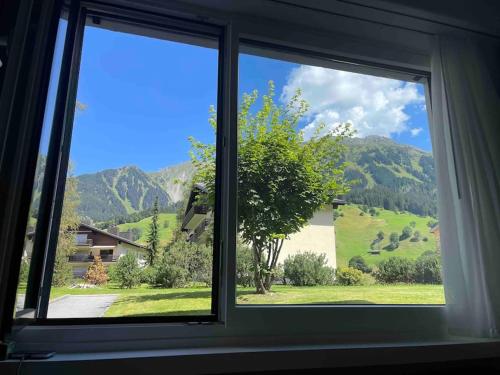 a window with a view of a mountain view at Mountain View Studio Klosters in Klosters