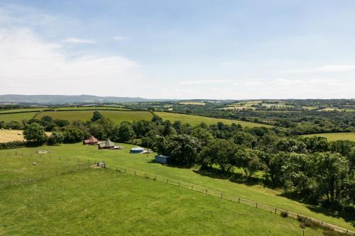 an aerial view of a field with trees and a fence at Exmoor Eco-Pod - Oak Tree Lane in Okehampton
