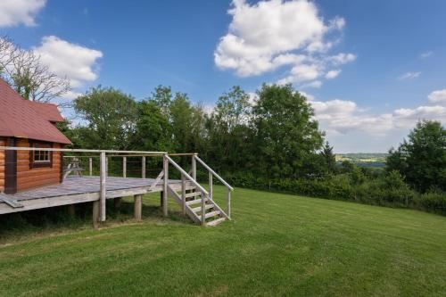 a wooden deck on a house with a grass field at Exmoor Eco-Pod - Oak Tree Lane in Okehampton