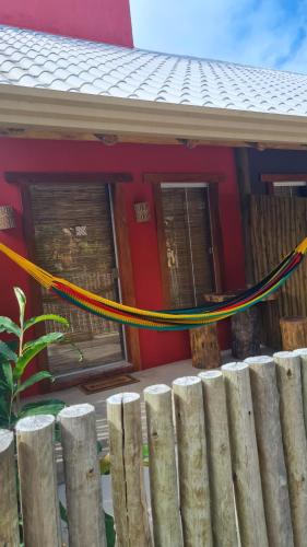 a house with a yellow rope in front of it at Chale Flat pousada do vini in Corumbau