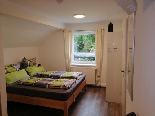 a small bedroom with a bed and a window at Kleine Wohnung (idyllische Lage) in Wutöschingen