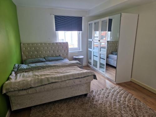 a bedroom with a bed and a mirror at Remarkable 1-Bed Apartment in Northampton Town cen in Northampton