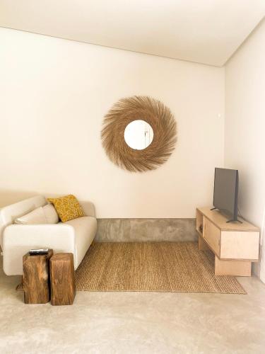 a living room with a couch and a tv at Casa do Rio in Leiria