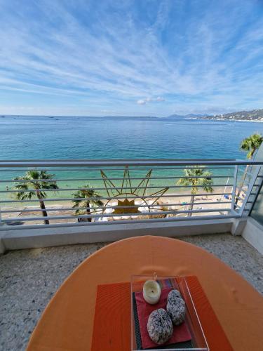 a table with donuts on a balcony with a view of the ocean at Soleil 2023 in Antibes