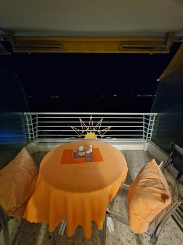 a table and two chairs on a balcony with a table at Soleil 2023 in Antibes