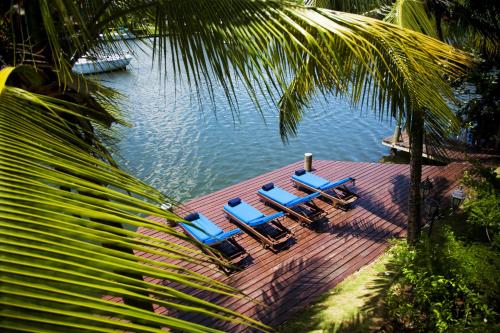 a group of chairs sitting on a dock in the water at Harmony Marina Suites in Rodney Bay Village