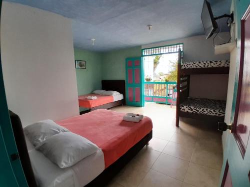 a bedroom with two beds and a bunk bed at Hostal Johnnier in Salento