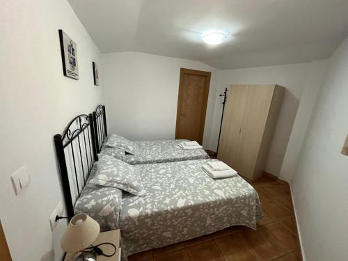 a small bedroom with a bed in a room at Cortijo Los Cahorros Sierra Nevada in Monachil