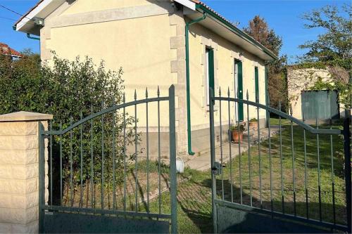 an iron gate in front of a house at Villa coutrillonne près St Emilion [clim salon] in Coutras