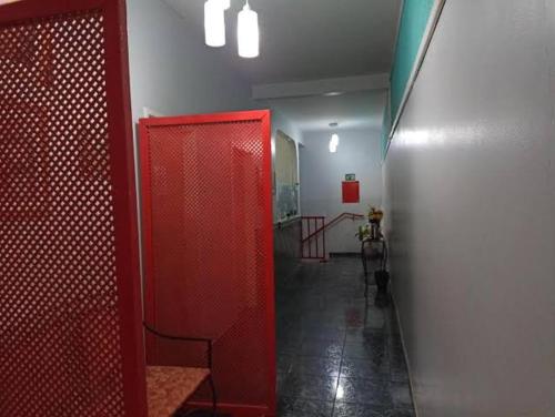 a hallway with a red stall in a bathroom at Hotel Canal Hum in Brasilia