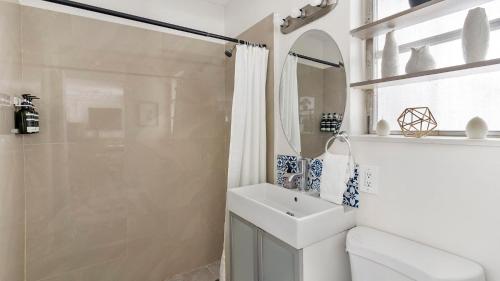 a white bathroom with a sink and a shower at Brickell Pearl Cozy House Beach 10 min Location in Miami