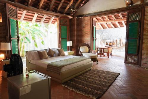 a bedroom with a bed and a table and chairs at Castillete in Cartagena de Indias