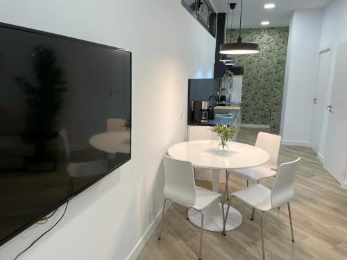 a dining room with a white table and chairs at office 25 in Tres Cantos