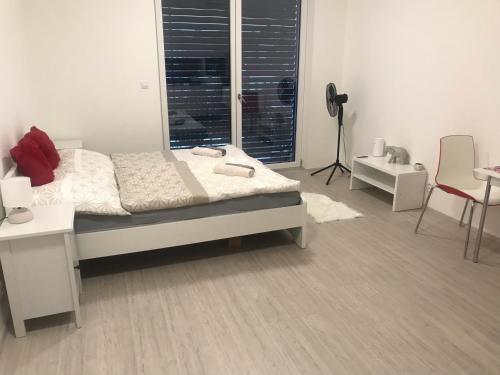 um quarto com uma cama, uma secretária e uma janela em Moderni byt s balkonem Brno-Kralovo pole em Brno