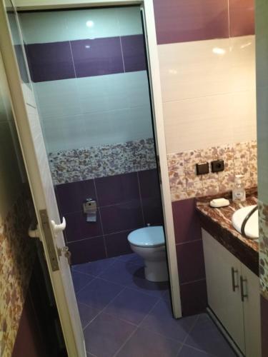 a bathroom with a toilet and a sink at Résidence alhouda in Agadir