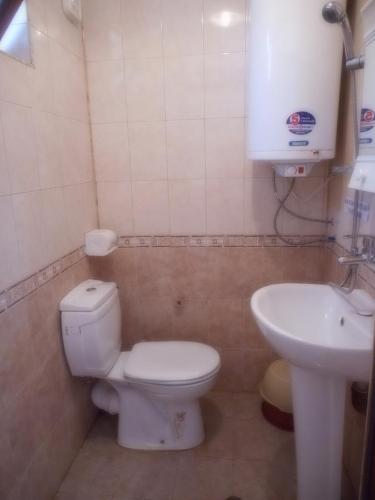 a bathroom with a toilet and a sink at Guest Rooms Ribarska Hizha in Shabla