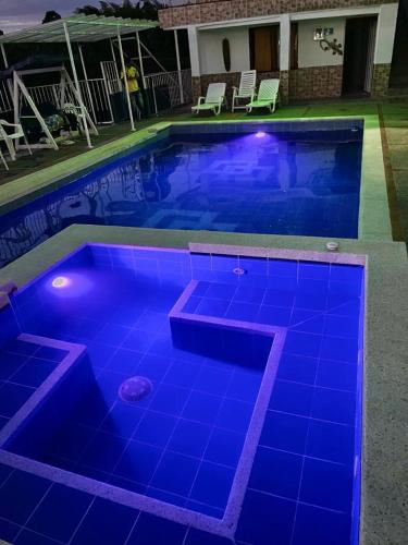 a swimming pool with blue lighting in a house at Finca Hotel VILLA SOFIA in Montenegro