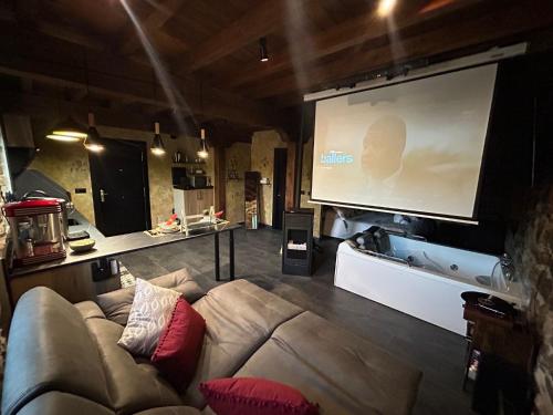 a living room with a couch and a projection screen at La Tentacion de Mazobre - La Suite de la Montaña Palentina in Alba de los Cardaños