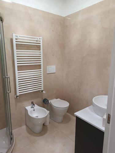 a bathroom with a toilet and a sink at Pirelli 28 in Milan