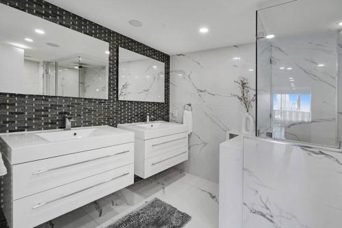 - Baño blanco con 2 lavabos y ducha en The Bond - OO7 Vibes and Penthouse Water Views!, en Miami