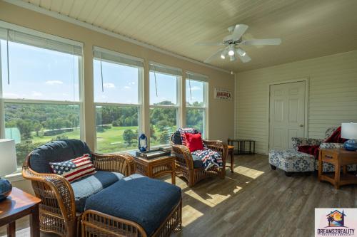 a living room with chairs and a couch and windows at 2BR WALK-IN - Golf Course View - Centrally Located - FREE TICKETS INCLUDED - FW11-3 in Branson