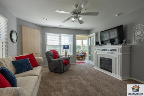 a living room with a couch and a tv and a fireplace at 2BR WALK-IN - Golf Course View - Centrally Located - FREE TICKETS INCLUDED - FW11-3 in Branson