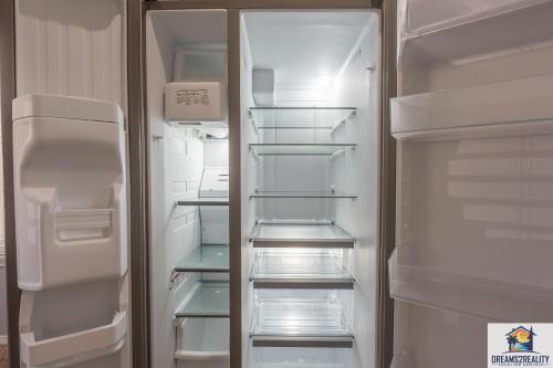an empty refrigerator with its door open and its shelves at 2BR WALK-IN - Golf Course View - Centrally Located - FREE TICKETS INCLUDED - FW11-3 in Branson