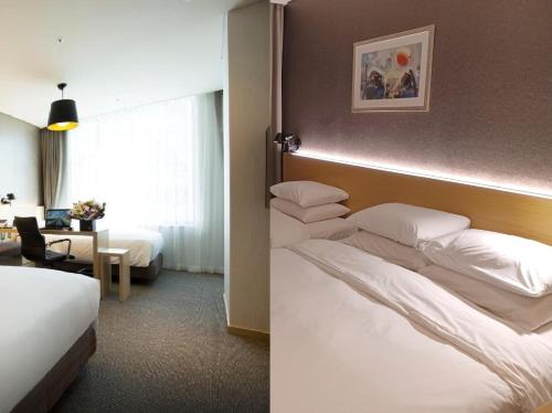 a hotel room with two beds and a room with at Arirang Hill Hotel Dongdaemun in Seoul