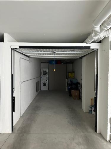 an empty garage with a door open in a building at Luxury Sofia Home Alghero in Alghero