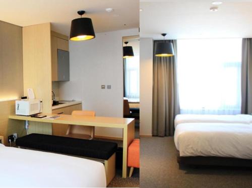 a hotel room with a bed and a desk and a room at Arirang Hill Hotel Dongdaemun in Seoul