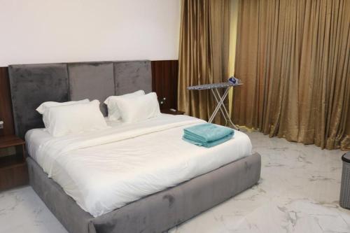 a large bed in a room with a camera at Excellent 2 bed apartment in Lekki Phase1 With SuperFast Wi-fi & 247 Power in Lekki