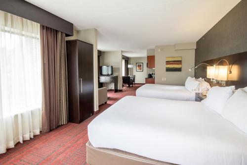 a hotel room with two beds and a large window at Holiday Inn Express Hotel & Suites Auburn by IHG in Auburn