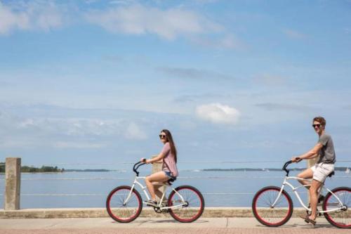a man and a woman riding bikes on the beach at Hotel Indigo - Panama City Marina by IHG in Panama City