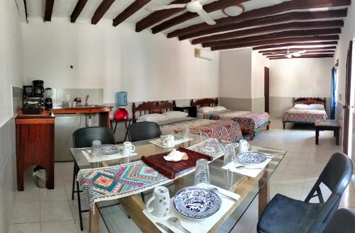 a dining room with a table and chairs at Posada los abuelos in Holbox Island
