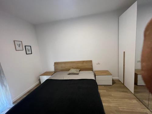 um quarto com uma cama e uma parede branca em Feeling Home 2 em Oradea