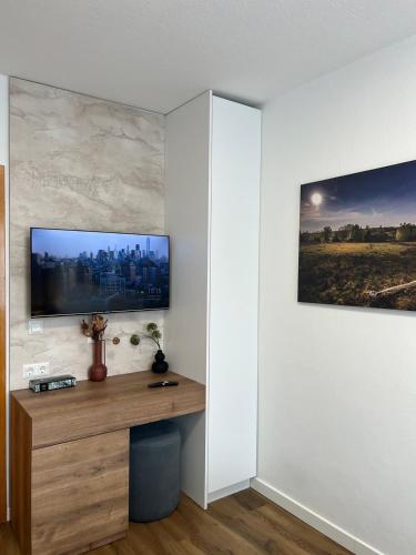 a living room with a tv on a wall at Ferienwohnung E in Soltau