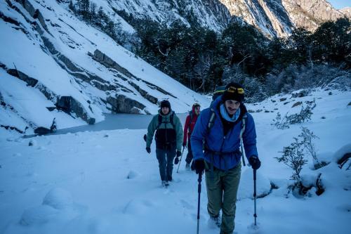 three people cross country skiing in the snow at INDÓMITO HOSTEL in San Carlos de Bariloche