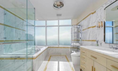 a bathroom with a shower and a tub and a toilet at Luxury apartments in Los Angeles