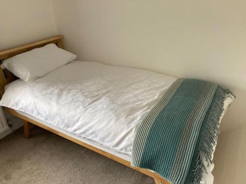 a small bed with a wooden frame and a pillow at Coniston House Lancaster 3 bedrooms Parking and Garden in Lancaster