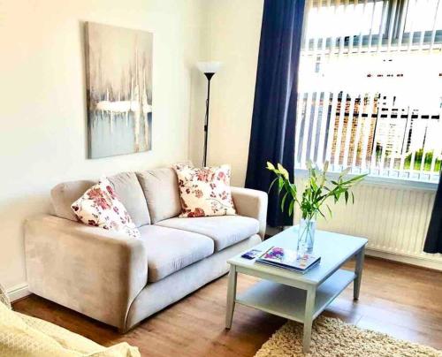 a living room with a couch and a table at Coniston House Lancaster 3 bedrooms Parking and Garden in Lancaster
