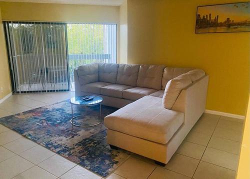 a living room with a couch and a table at Amazing Guest House in West Palm Beach