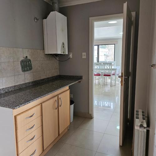 a kitchen with a counter and a dining room at CONDOR Patagonia Aparts in El Calafate