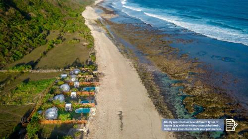 an aerial view of a beach with tents and the ocean at Bubble Hotel Nyang Nyang - Adults only in Uluwatu