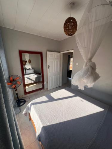 a bedroom with a bed and a mirror at Bantuz in Livingstone