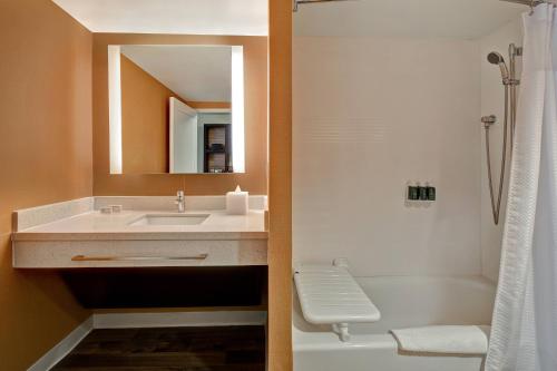a bathroom with a sink and a toilet and a shower at TownePlace Suites Las Vegas Airport South in Las Vegas