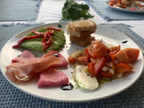 a plate of food with meat and vegetables on a table at Casa Hermosa Mijas in Mijas