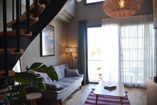a living room with a couch and a large window at Soas Suites in Alacati