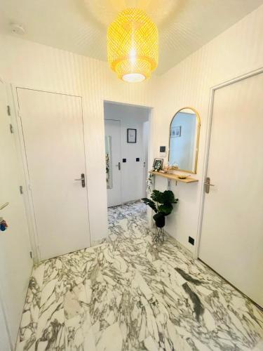 a hallway with a marble floor and a chandelier at New apartment at 150m from the beaches Easy check in in Juan-les-Pins