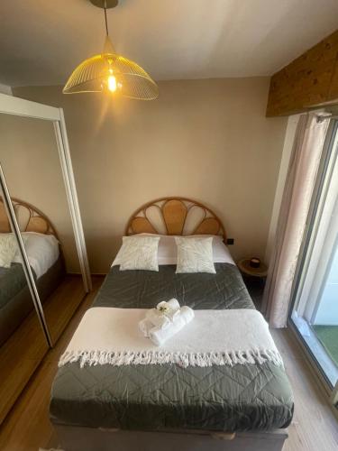 a bedroom with a bed and a large window at New apartment at 150m from the beaches Easy check in in Juan-les-Pins
