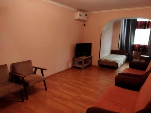 a living room with a couch and a bed at Apartment on Abazgaa 53-4 in Gagra
